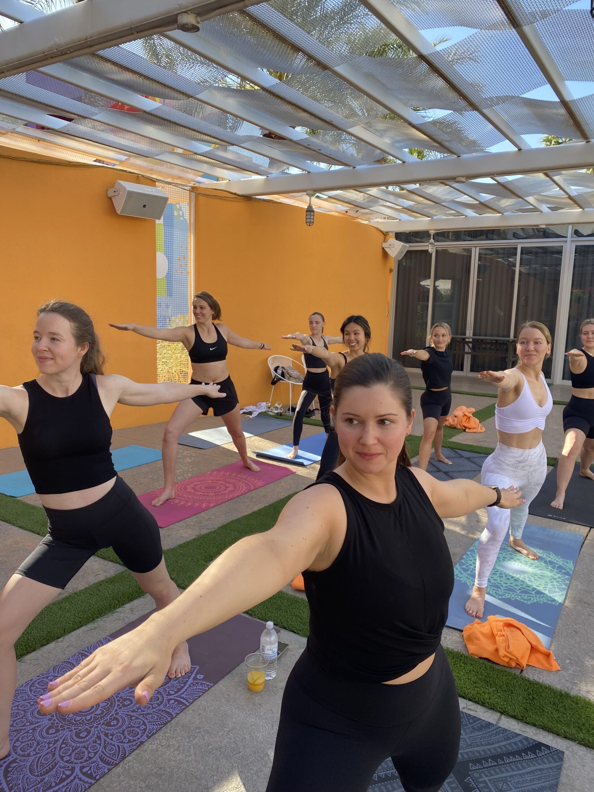 A group of people doing yoga in the sun.